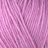 Detailed view of a skein of superwash wool yarn, showcasing a pink hue.