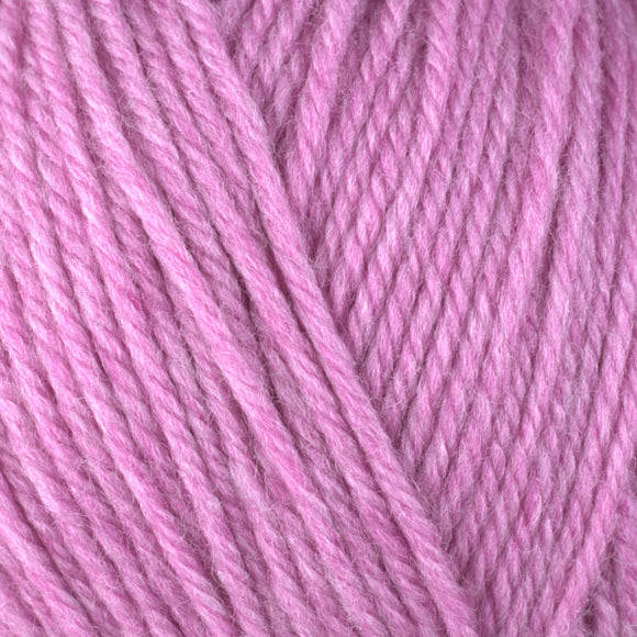 Detailed view of a skein of superwash wool yarn, showcasing a pink hue.