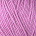 Detailed view of a skein of superwash wool yarn, showcasing a pink hue.
