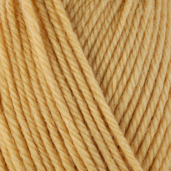 Detailed view of a skein of superwash wool yarn, showcasing a yellow hue.