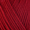 Detailed view of a skein of superwash wool yarn, showcasing a red hue.