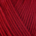 Detailed view of a skein of superwash wool yarn, showcasing a red hue.