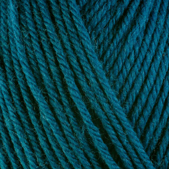 Detailed view of a skein of superwash wool yarn, showcasing a teal hue.