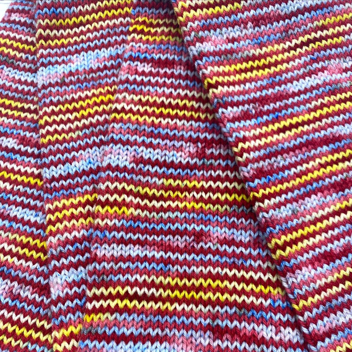 Knitted Wit HerStory 2023: New Galoshes yarn colors red blue and yellow