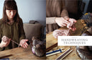 Woman demonstrating handweaving techniques with yarn and tools on a wooden table.