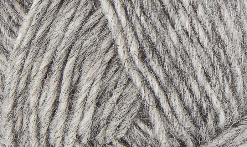 A close up photo of light gray Istex  Lettlopi yarn