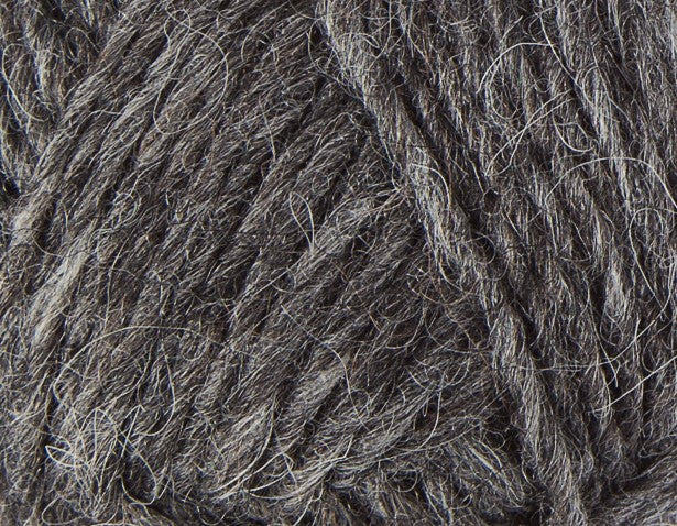 A close up photo of dark gray Istex Lettlopi yarn