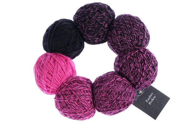 A pink and black set of Schoppel Zauber Perlen yarn balls