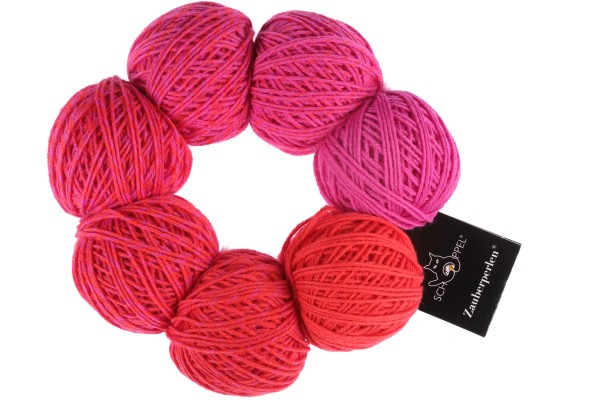 An orange and pink set of Schoppel Zauber Perlen yarn balls