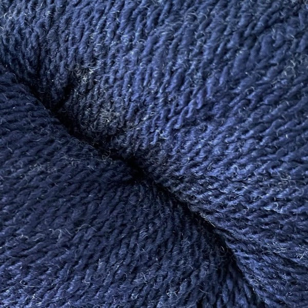 A rich blue hank of the Mountain Meadow Wool Saratoga yarn collection