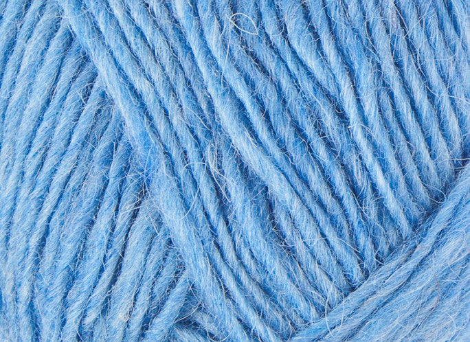 A close up photo of blue Istex Lettlopi yarn