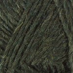 A close up photo of dark green Istex Lettlopi yarn