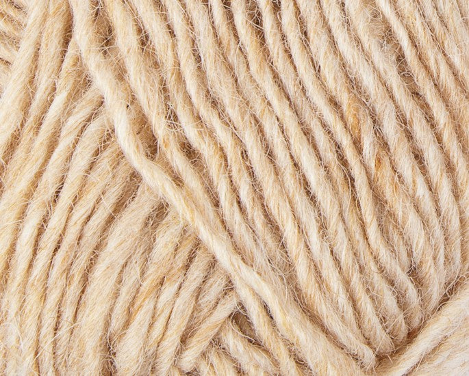 A close up photo of natural cream Istex Lettlopi yarn