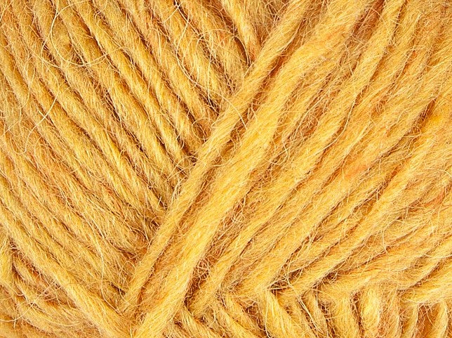 A close up photo of yellow Istex Lettlopi yarn