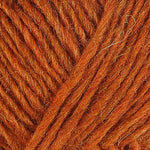 A close up photo of orange Istex Lettlopi yarn