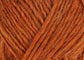 A close up photo of orange Istex Lettlopi yarn