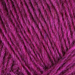 A close up photo of magenta Istex Lettlopi yarn
