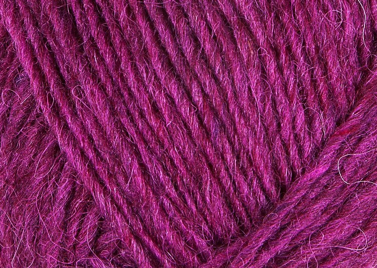 A close up photo of magenta Istex Lettlopi yarn
