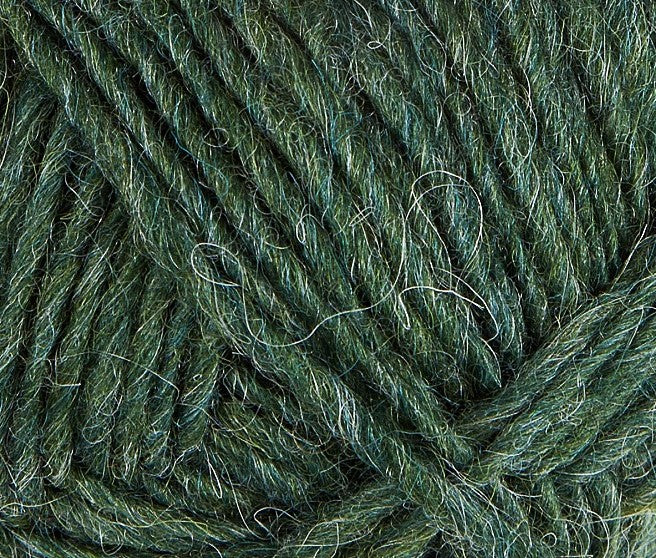 A close up photo of dark green Istex Lettlopi yarn