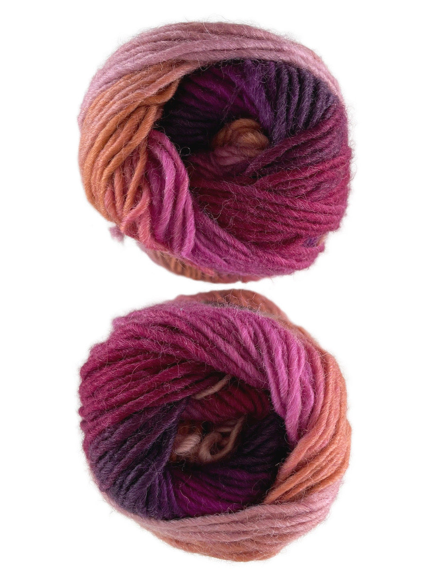 A photo of two purple, orange, and red skeins of yarn
