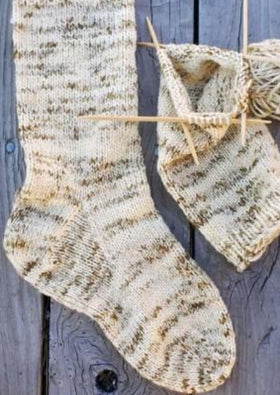 A pair of knitted socks on knitting needles