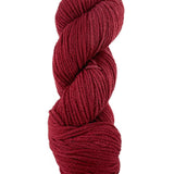 A red skein of Mountain Meadow Wool Cora yarn