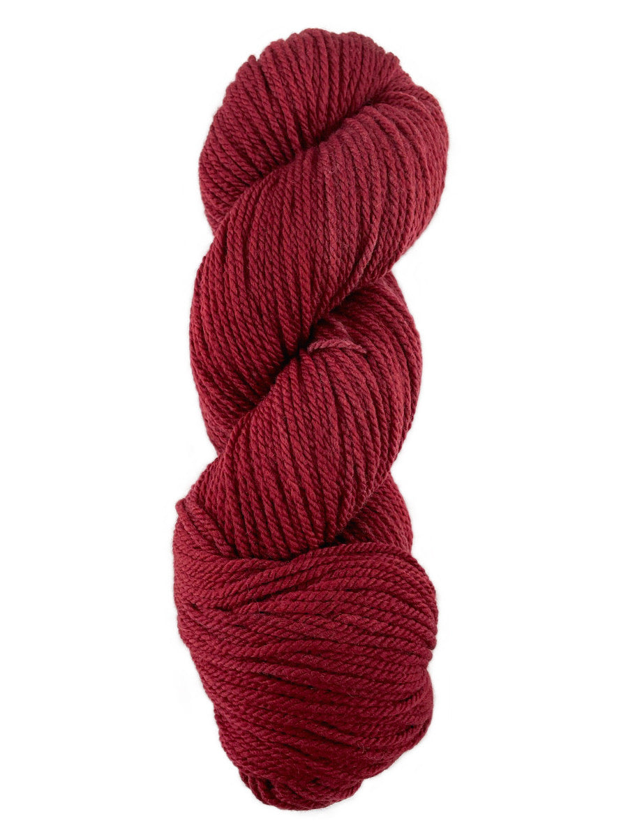 A red skein of Mountain Meadow Wool Cora yarn