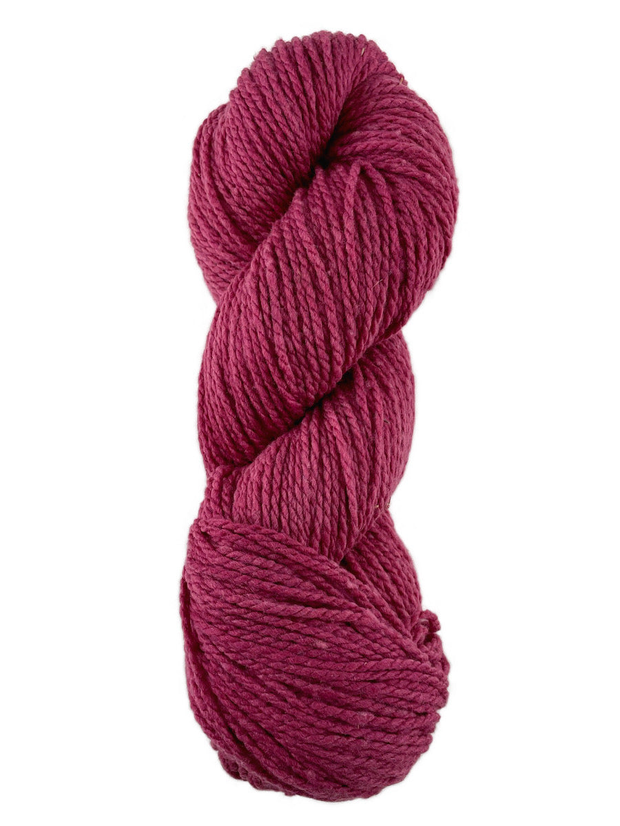 A redish pink skein of Mountain Meadow Wool Laramie yarn