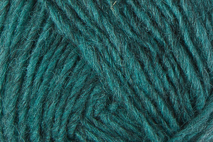 A close up photo of teal Istex Lettlopi yarn