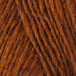 A close up photo of orange Istex Lettlopi yarn
