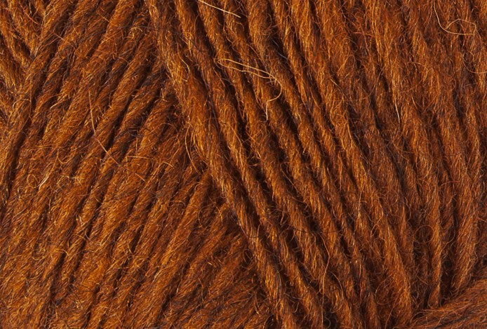 A close up photo of orange Istex Lettlopi yarn
