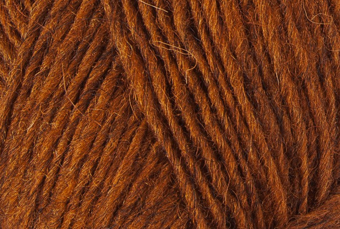 A close up photo of orange Istex Lettlopi yarn