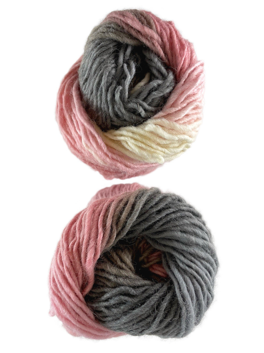 A photo of two gray, pink, and white skeins of yarn