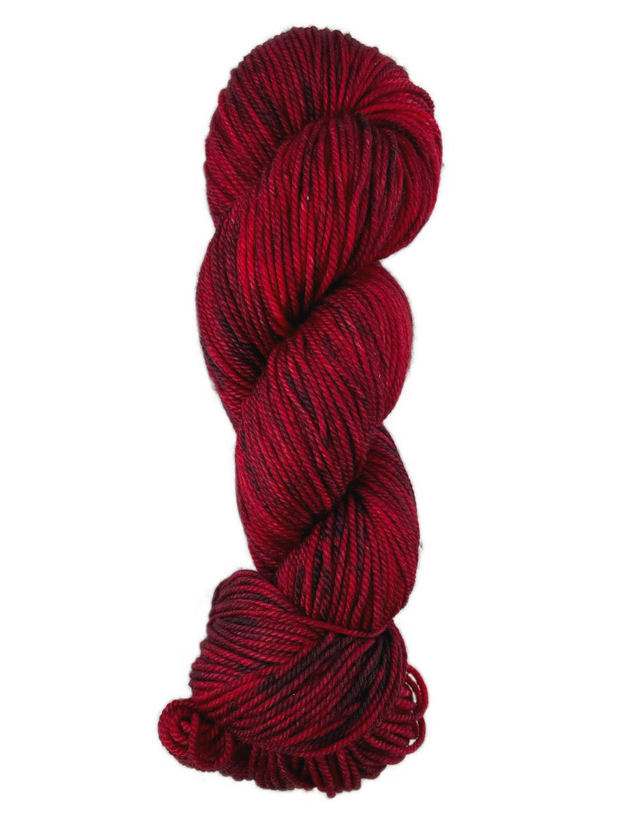A red skein of Western Sky Knits Merino 17 DK yarn
