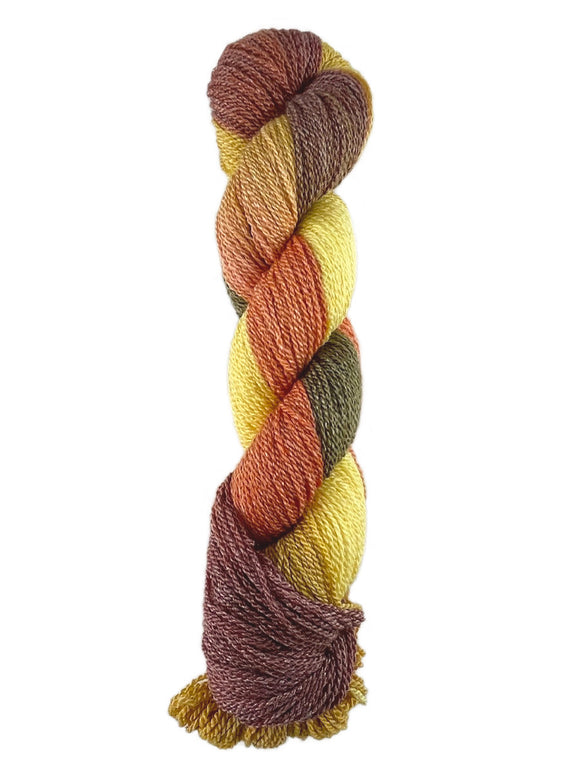 A multi-color brown, yellow, orange, and dark green skein of Mountain Meadow Wool Green River yarn