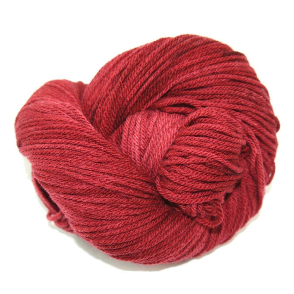 A reddish-pink hank of the Mountain Meadow Wool Alpine collection.