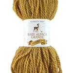 A gold skein of Plymouth Baby Alpaca Grande yarn