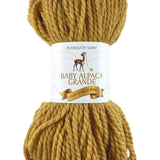 A gold skein of Plymouth Baby Alpaca Grande yarn