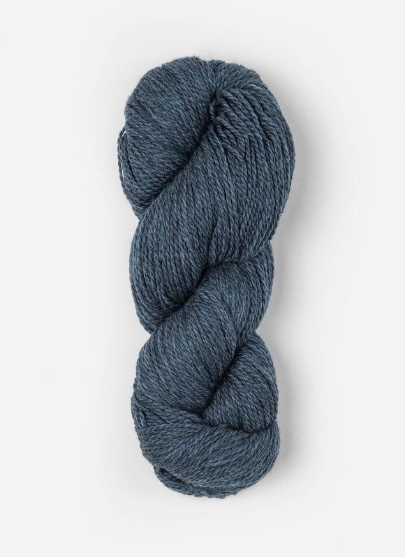 Skein of Blue Sky Fibers Woolstok yarn in the color denim blue