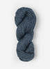 Skein of Blue Sky Fibers Woolstok yarn in the color denim blue