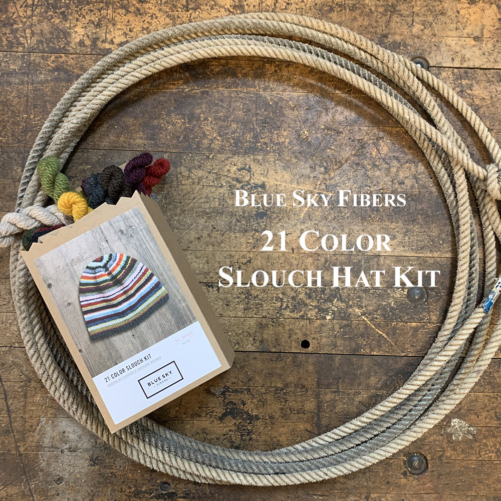 Photo of a Blue Sky Fiber Woolstok yarn Hat Kit in a lasso on a wooden surface
