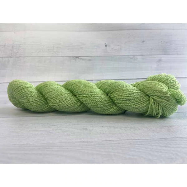 A light green skein of Mountain Meadow Wool Green River yarn