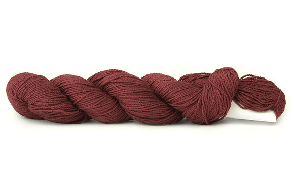 A photo of a wine colored hank of CoBaSi sock yarn.
