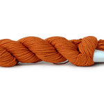 A photo of a carrot colored hank of CoBaSi sock yarn.