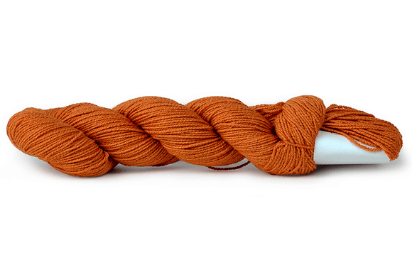 A photo of a carrot colored hank of CoBaSi sock yarn.