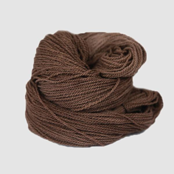 A brown hank of the Mountain Meadow Wool Saratoga yarn collection