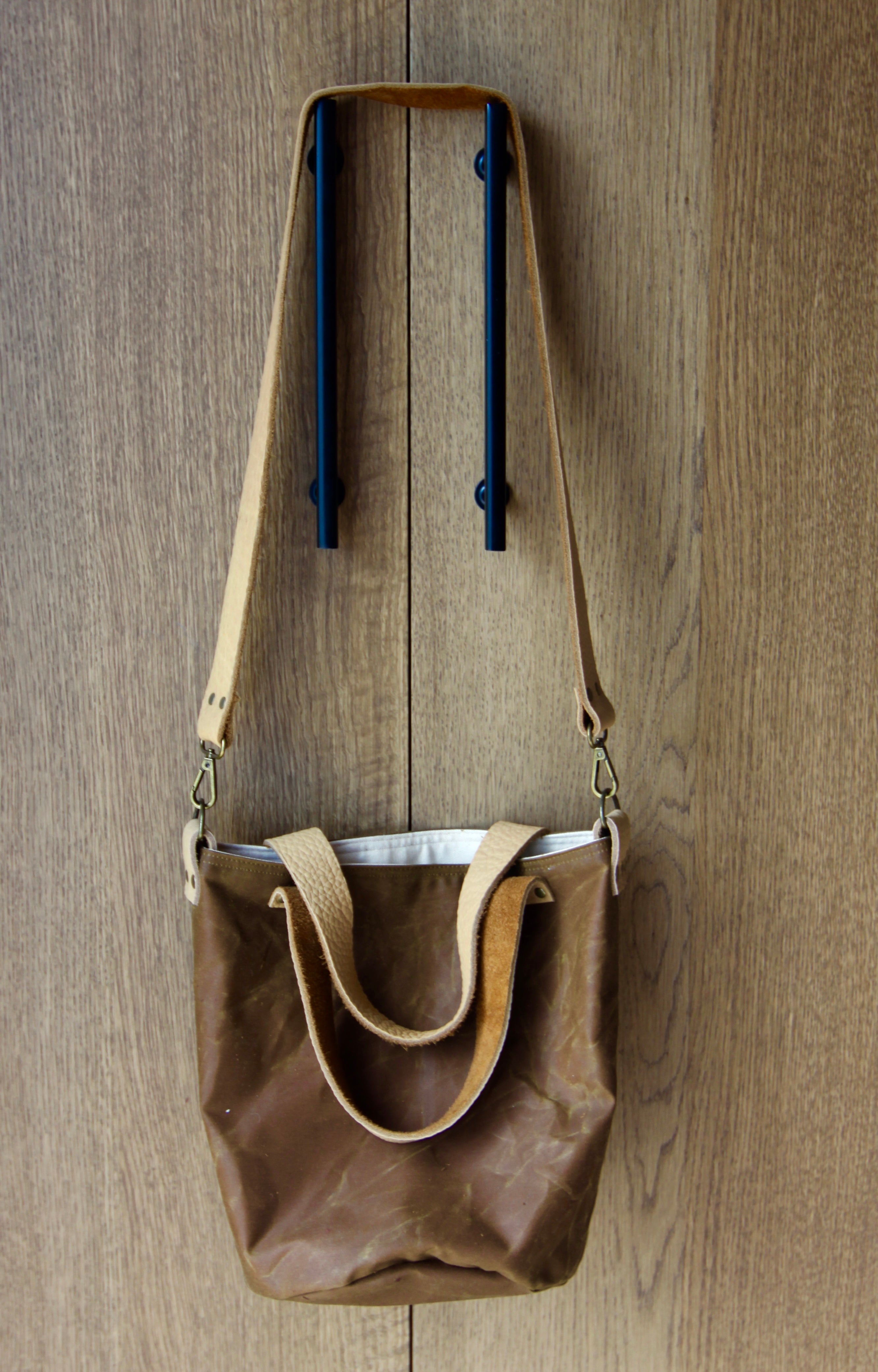 A brown bag with 3 handles