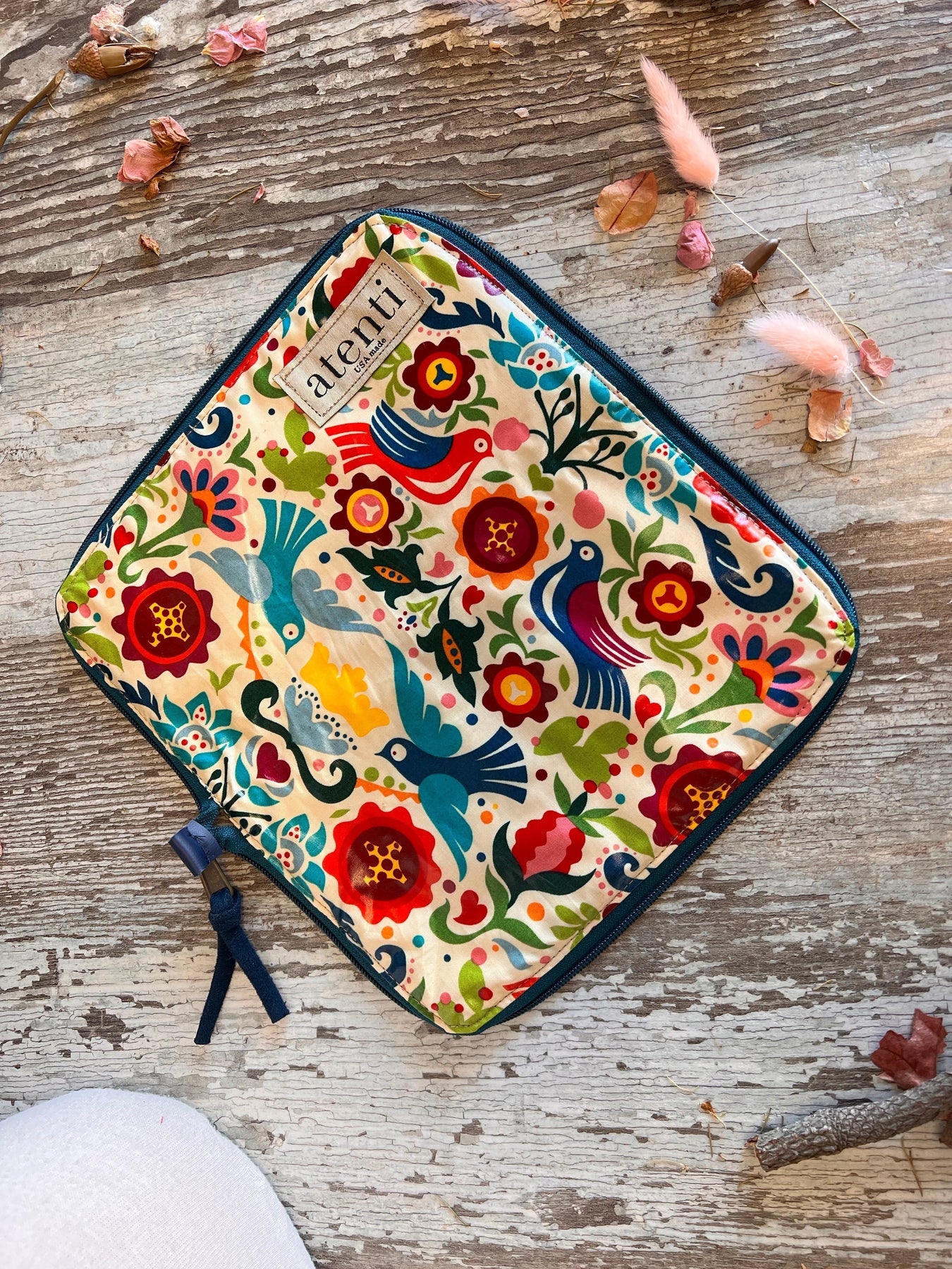 An Atenti bag in folk style fabric featuring birds and flowers