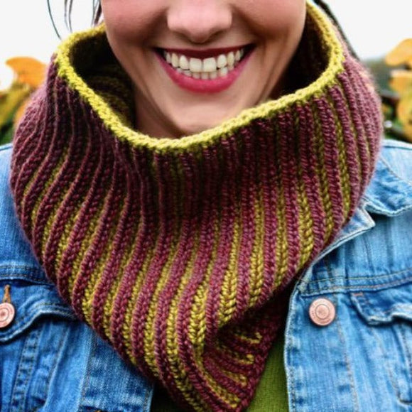 A woman wearing a knitted, brioche cowl