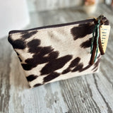 Close up of Atenti pouch in cowhide fabric